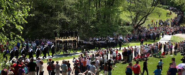 Hearse winds down the road to the Receiving Vault where thousands wait